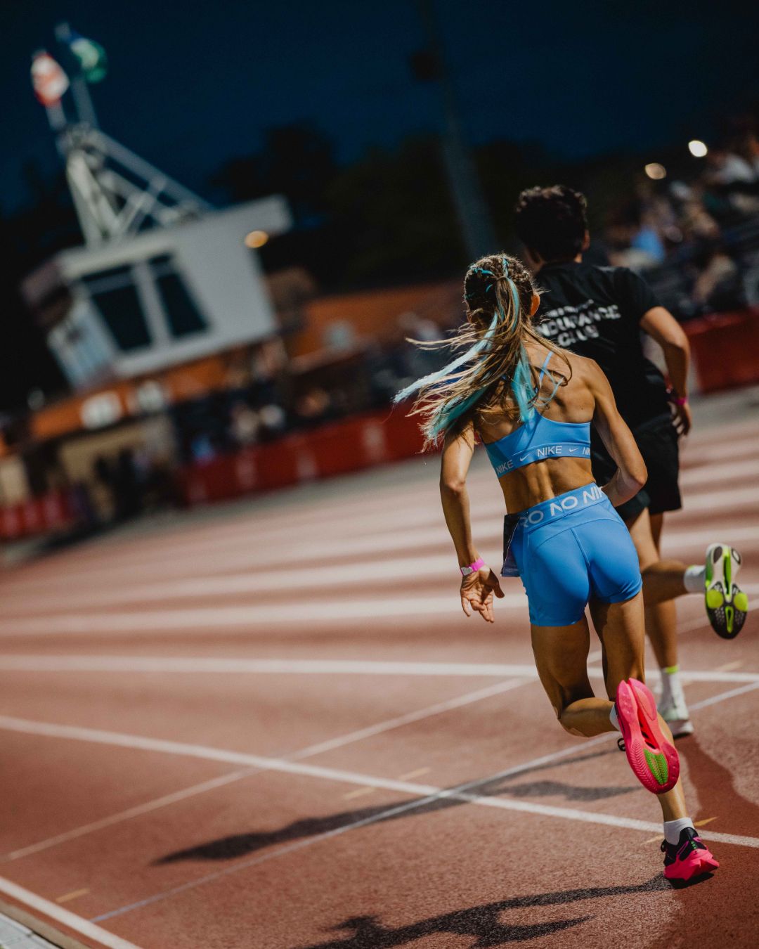 Runners on the track at night